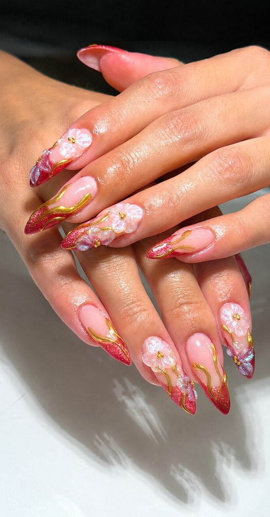 Pink floral gel nails with gold lines and red tips